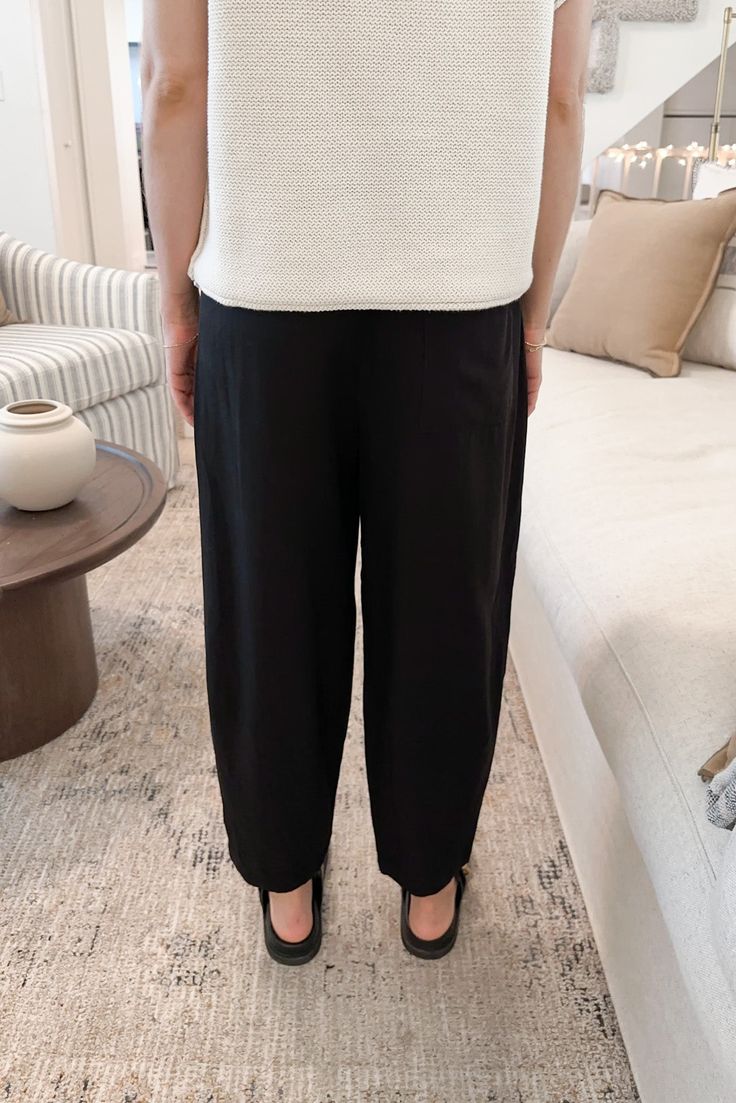 The Laney Tencel Tapered Pants in Black are so lightweight and ready to be paired with your favorite summer blouse. Featuring pleated details, black color, side and back pockets, tapered silhouette, half elastic waistband, zipper closure and a true to size fit. Style these amazing pants with a white tee or knit blouse! Details & Sizing Pleated details Black color Side and back pockets Tapered silhouette Zipper Half elastic waist True to size fit Gabriella is wearing a size S Sizing S Waist:28" I Summer Blouses, Tapered Pants, Sweater Set, Black Color, Elastic Waist, Sweater Dress, Topshop, Plus Size, Pants