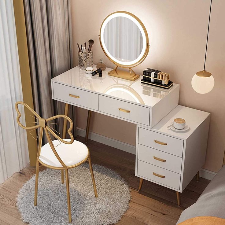 a bedroom with a white vanity and gold accents