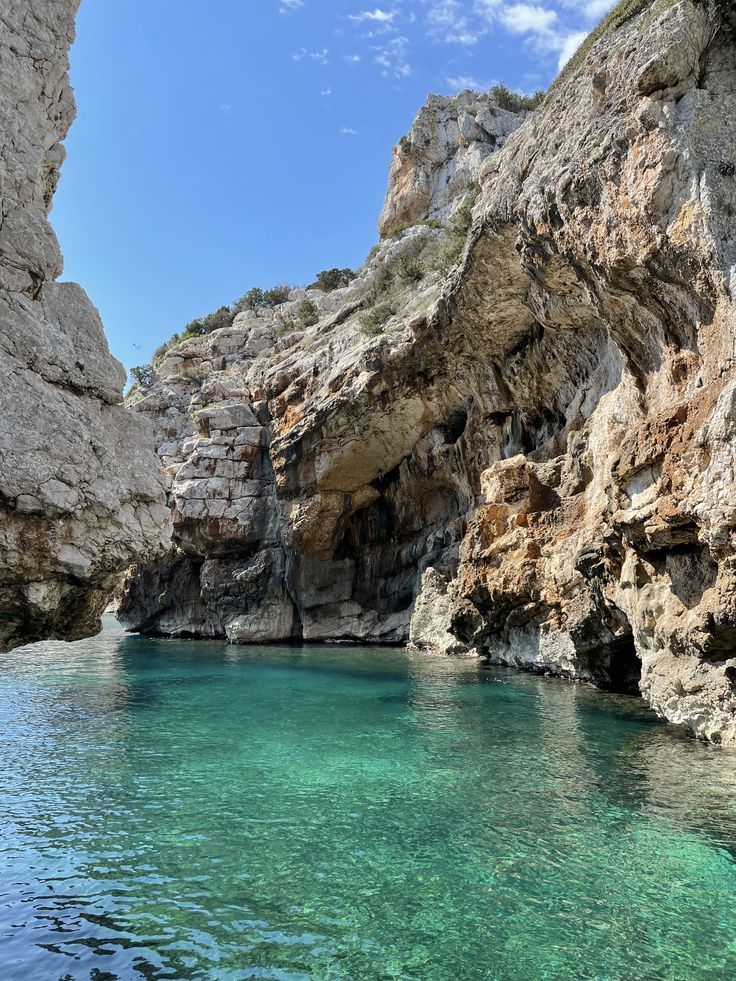 the water is crystal blue and clear at this beach in croatia, where you can see cliffs on either side