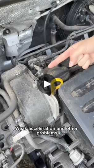 a person pointing to the engine compartment on a car