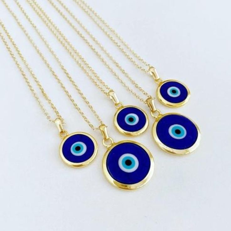 Ward off bad vibes in style with our Blue Turkish Evil Eye Necklace. Perfect for any occasion (except maybe a séance), this necklace features a stunning blue evil eye charm on a delicate chain. Keep the negativity away, all while looking fabulous. This necklace is combination of; - dark blue glass evil eye bead - stainless steel gold chain 15mm Charm Made in Turkey Blue Pendant Charm Necklaces For Spiritual Style, Spiritual Blue Charm Necklace, Blue Evil Eye Pendant Necklace, Blue Evil Eye Charm Necklace, Blue Pendant Charm Necklace With Adjustable Chain, Blue Amulet Charms Necklace, Blue Amulet Jewelry With Adjustable Chain, Nickel Free Blue Amulet Necklace, Blue Nickel-free Pendant Charm Necklaces