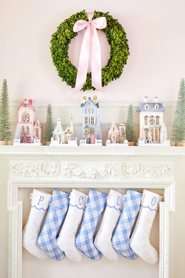 stockings hung on the mantel with christmas decorations