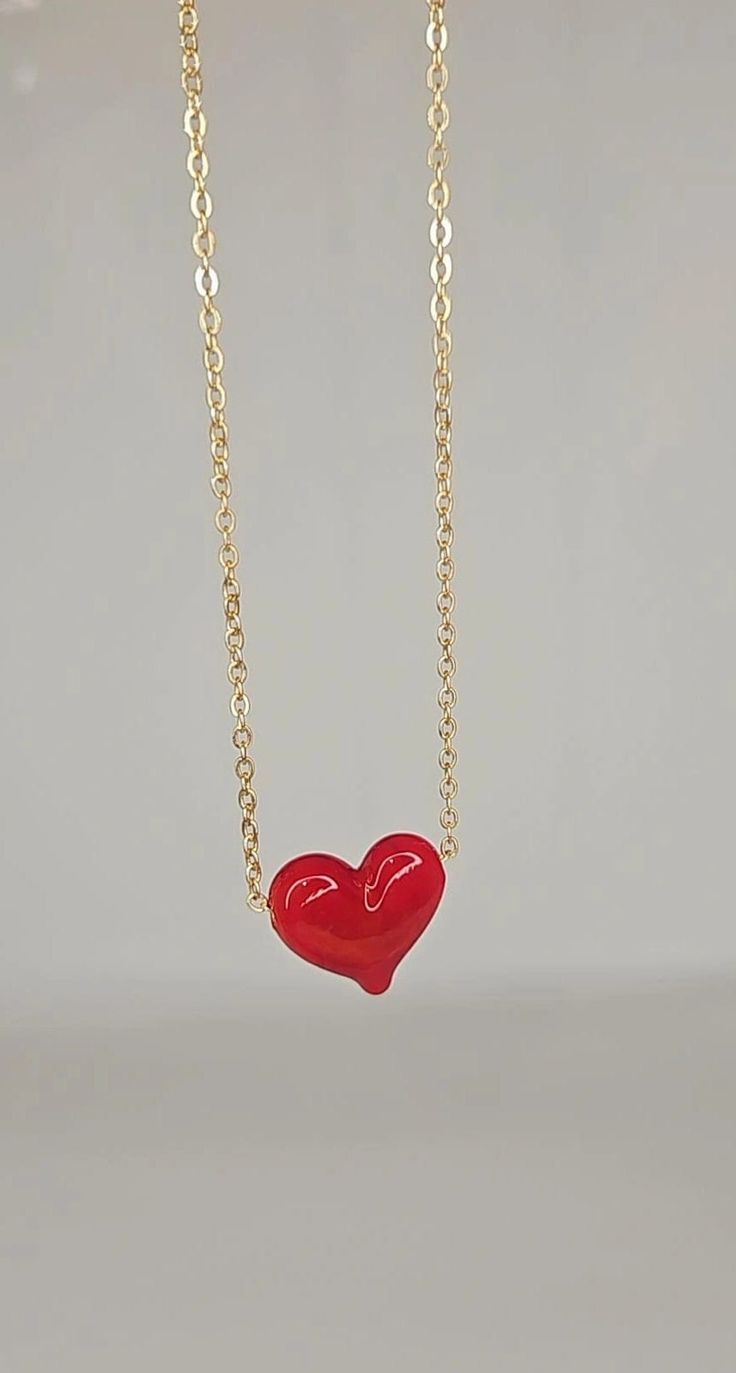 Discover the jewel that will steal hearts! Introducing our exquisite "Fiery Heart" necklace. Each heart, meticulously handcrafted in authentic red Murano glass, exudes passion and elegance. Its 24k gold plated chain adds a touch of sophistication and luxury to this unique piece. With the "Fiery Heart" necklace, you will carry with you the symbol of love in its most dazzling form. Every detail has been carefully worked on to create a jewel that will not go unnoticed. Whether for a special occasion or simply to highlight your unique style, this necklace is the perfect choice. Don't settle for ordinary jewelry. Let the "Fiery Heart" necklace be your bold and passionate style statement. Dare to stand out from the crowd and captivate everyone's eyes with this jewelry masterpiece! The Necklace m Adjustable Heart Shaped Clavicle Chain Necklaces, Valentine's Day Clavicle Chain With Heart Pendant, Valentine's Day Heart Pendant Clavicle Chain, Valentine's Day Heart-cut Heart Beads Jewelry, Valentine's Day Clavicle Chain Pendant Necklace, Heart Pendant Necklace With Adjustable Chain, Heart-shaped Jewelry With Adjustable Chain For Valentine's Day, Double Heart Beads Necklaces For Jewelry Making, Heart-shaped Adjustable Chain Jewelry For Valentine's Day