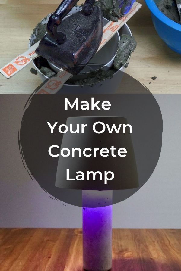 a purple lamp sitting on top of a wooden table next to a blue bowl filled with dirt