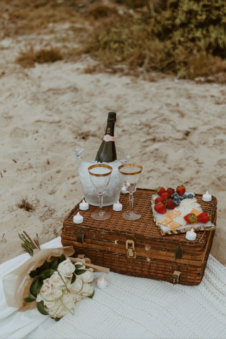 two wine glasses sitting on top of a suitcase