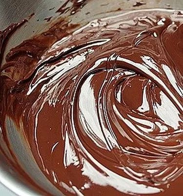 melted chocolate in a metal bowl on a table