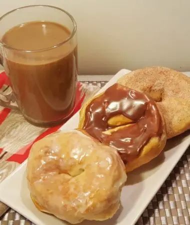 two donuts and a cup of coffee on a table