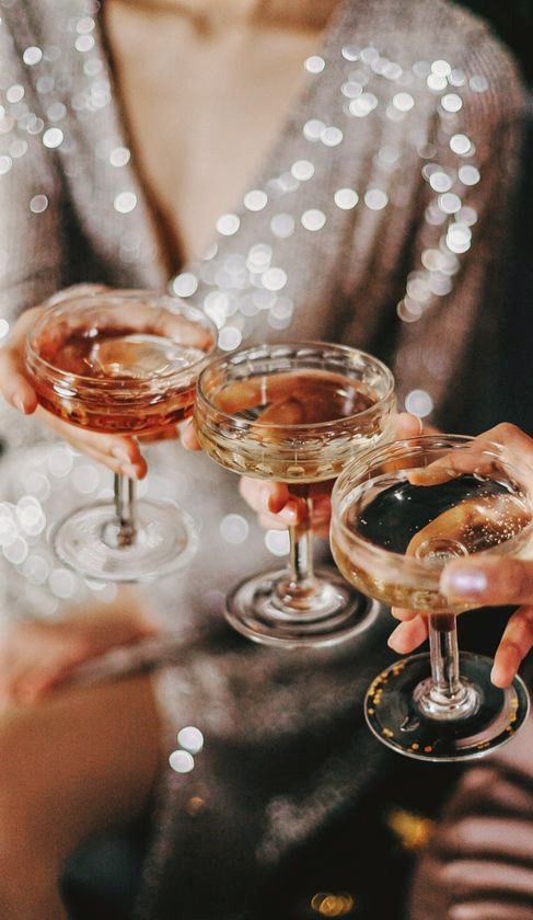 two people holding up wine glasses in their hands