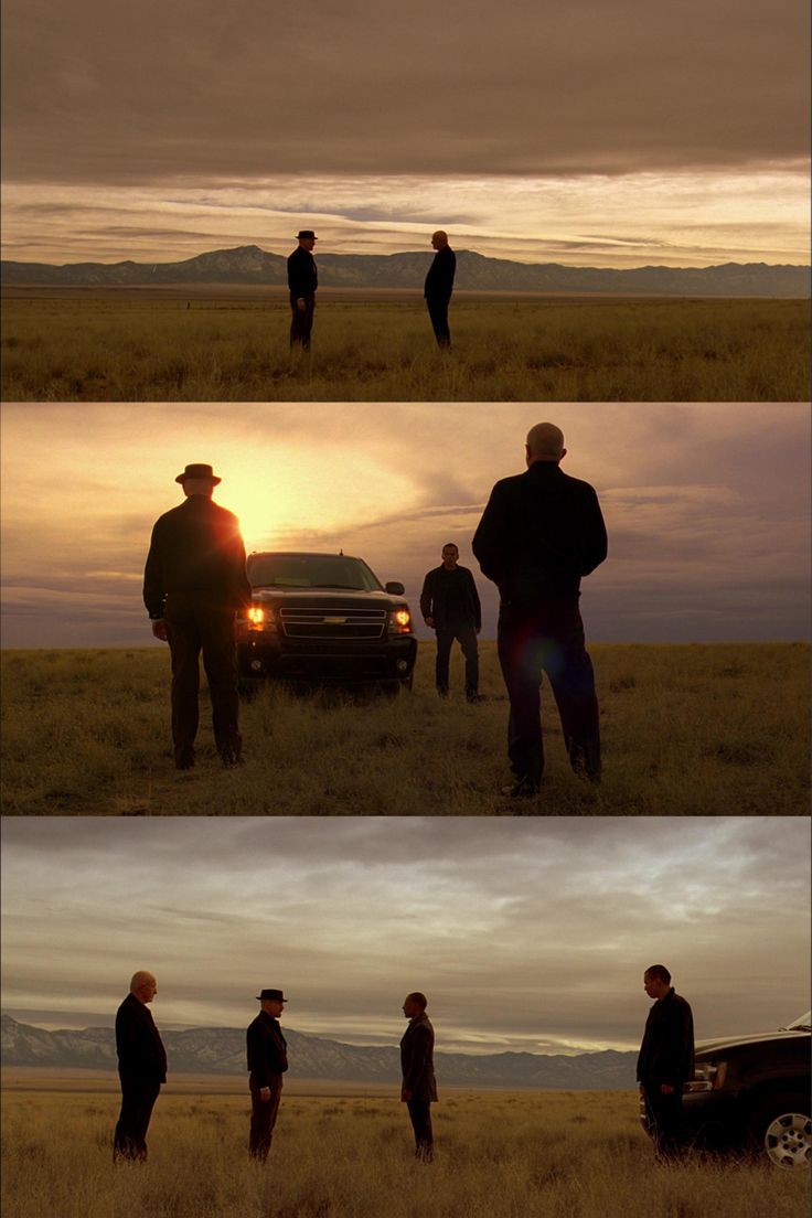 three men standing in front of a truck at sunset