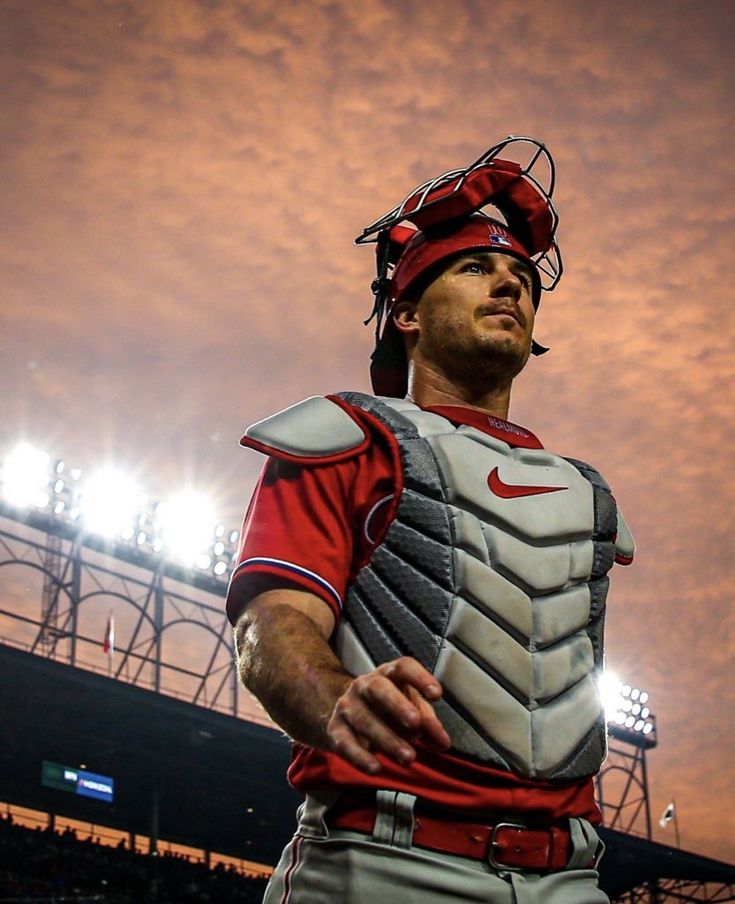 a baseball player wearing a catchers mitt in front of a stadium filled with people