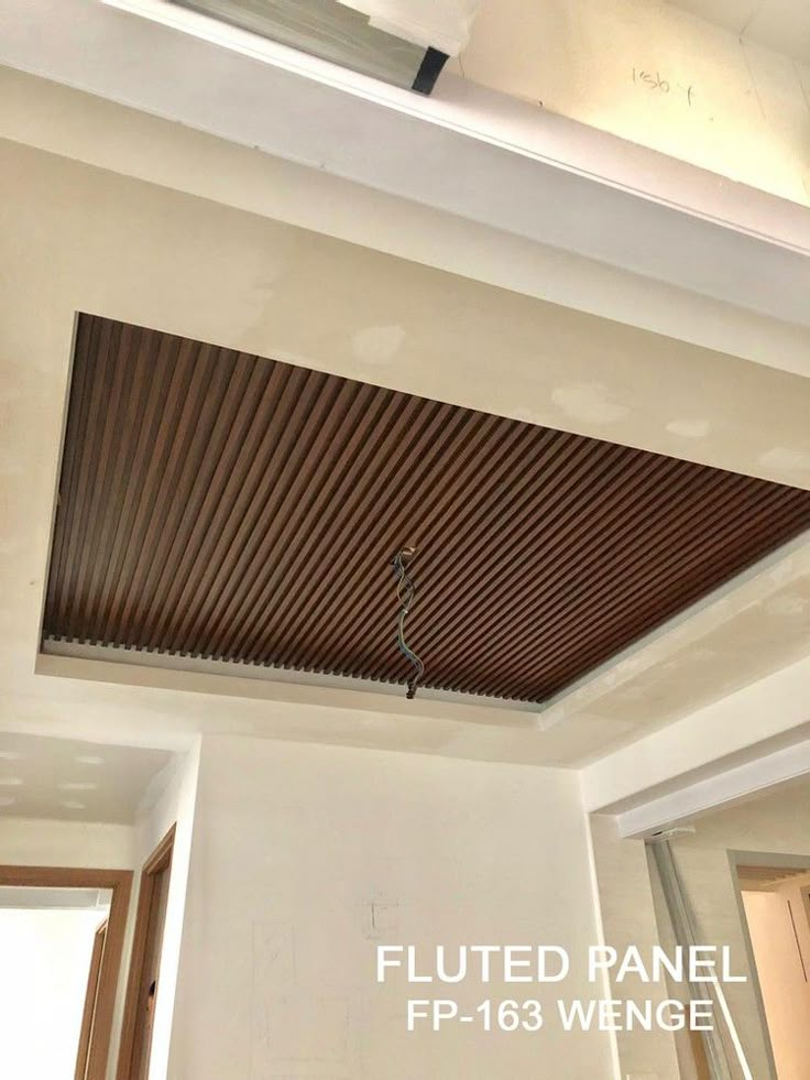 the ceiling is covered in wood slats and has a light fixture on it's side