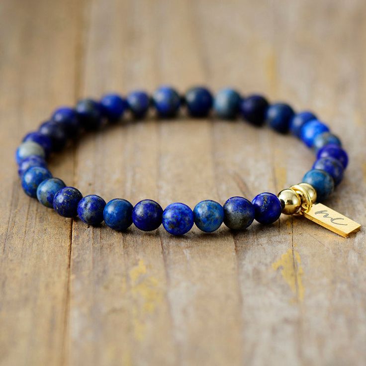 The Handmade Natural Lapis Lazuli Beaded Bracelet with a Gold Plated Tag looks great. It will make the perfect gift 🎁 for someone special, or treat yourself as you deserve it 💖 🥰 These Bracelets have been made using high quality Natural Lapis Lazuli and have a Gold Plated Tag with MC for MantraChakra. They are available as 4mm, 6mm and 8mm. Lapis Lazuli brings out your inner priestess, heightens inner-vison and deepens wisdom. It benefits the Throat Chakra with communication and expression of Gift Lapis Lazuli Round Bead Bracelets, Gift Lapis Lazuli Bracelets With Round Beads, Lapis Lazuli Bead Bracelet Gift, Gift Lapis Lazuli Beaded Bracelets With Polished Beads, Lapis Lazuli Beaded Bracelet Gift, Lapis Lazuli Gemstone Beads Bracelet For Gift, Lapis Lazuli Gemstone Beaded Bracelet For Gifts, Lapis Lazuli Beaded Bracelets As Gift, Minimalist Polished Beads Bracelets As Gift