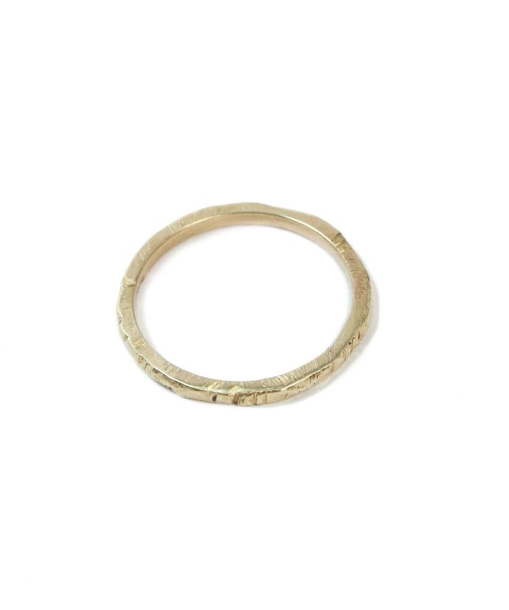 Custom sized in approx. 2-3 weeks unless in stock. Please contact us about rush orders. The Ragged Series are organic versions of traditional wedding bands. The texture, originally created by accident, is carved on each ring individually so no two rings are ever the same. Specifications: 14k yellow, white gold or rose gold. Photo shows 1.5mm width. Images on hand show 1.5mm and 2mm widths on a size 4.5 finger. For engraving, you can leave a note with your request when checking out, 25 characters Yellow Gold Hammered Stackable Rings, Gold Hammered Stackable Rings For Promise, Hammered Stackable Rings In Recycled Gold, Hammered Recycled Gold Stackable Rings, Heirloom Yellow Gold Engraved Stackable Rings, Heirloom Engraved Yellow Gold Stackable Rings, Stackable Bands In Recycled Gold, Stackable Recycled Gold Bands, Yellow Gold Engraved Ring With Recycled Material