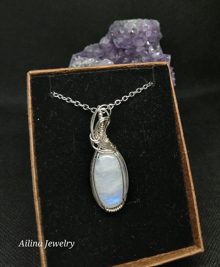 Crystal/Stone: Rainbow Moonstone Tourmaline. Pendant Length: 1 3/4 inches long Wire wrap metal: sterling silver Chain: stainless steel chain with claw clasp measures about 18 inches in length. Spiritual Hand Wrapped Oval Pendant Jewelry, Adjustable Wire Wrapped Sterling Silver Necklace, Silver Adjustable Teardrop Crystal Necklaces, Silver Adjustable Teardrop Crystal Necklace, Adjustable Sterling Silver Wire Wrapped Necklace, Mystical Moonstone Jewelry With Large Stone, Silver Oval Pendant Crystal Necklace For Gift, Unique Hand Wrapped Oval Pendant Jewelry, Silver Teardrop Wire Wrapped Crystal Necklaces