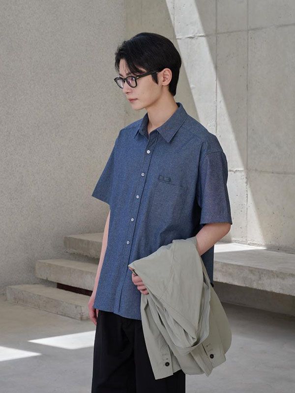 This is lightweight comfortable oversized shirt made from cotton chambray that will create natural washed look by wearing like denim. It's versatile for both casual and classic styling wearing as solo or under the jacket.- Collared neck- Button fastenings - One chest pocket and pencil holder- Short sleeves- Curved hem- Oversized fit Casual Denim Blue Summer Shirt, Casual Denim Blue Shirt With Pockets, Summer Chambray Denim Shirt, Casual Denim Shirt For Summer, Light Indigo Relaxed Fit Shirt For Summer, Light Indigo Summer Shirt, Relaxed Fit, Oversized Cotton Shirt With Roll-up Sleeves, Summer Denim Blue Shirt For Work, Summer Denim Blue Shirt For Workwear