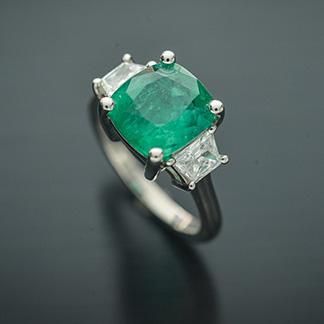 This Elegant Platinum three stone ring has a Natural Cushion Cut Colombian Emerald from the Top Muzo Mine with a GIA Certificate. The side stones are Natural Brilliant Cut Trapezoid Pair of Matching Diamonds. GIA#5202111099 3.34 Carat Cushion Modified 9.64x8.93x5.64 with moderate F2 clarity enchancement. 2 Matching Trapezoid Brilliant Cut Diamonds weigh 0.71 carats total weight and are graded G in color and SI1 to SI2 in clarity. Platinum weight is 5.14 DWT. Ring can be sized. Luxury Three Stone Gemstones For Anniversary, Three Stone Diamond Gemstones For Anniversary, Luxury Three Stone Diamond Emerald Ring, Luxury Three Stone Emerald Jewelry, Green Three Stone Fine Jewelry, Classic Three Stone Emerald Jewelry, Luxury Three Stone Asscher Cut Emerald Ring, Luxury Three Stone Emerald Ring, Luxury Three-stone Emerald Ring