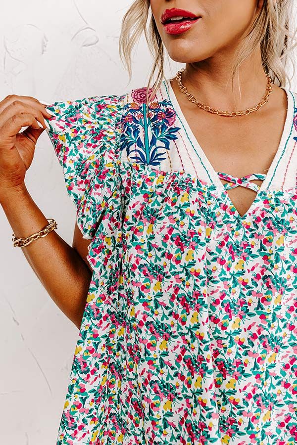 All eyes are sure to be on you in our photo-worthy 'Summer In Sicily' shift top featuring lightweight material patterned with a turquoise and fuchsia hued floral print, a v-cut neckline, ruffled cap sleeves, and a relaxed silhouette that falls into a straight hemline! on products Measurements XS : Bust 40", Hip 40", Length 21", Sleeve Length 4", Waist 40". S : Bust 42", Hip 42", Length 21", Sleeve Length 4", Waist 42". M : Bust 44", Hip 44", Length 21.5", Sleeve Length 4", Waist 44". L : Bust 46 Patterned Floral Print V-neck Top, Patterned V-neck Tops For Vacation, Summer V-neck Blouse With Floral Embroidery, Vibrant Print V-neck Top For Brunch, Summer V-neck Blouse With Ditsy Floral Print, Turquoise Floral Print Top For Spring, Summer Beach Tops With Split Neck, V-neck Tops With Floral Embroidery For Vacation, White Split Neck Top For Summer