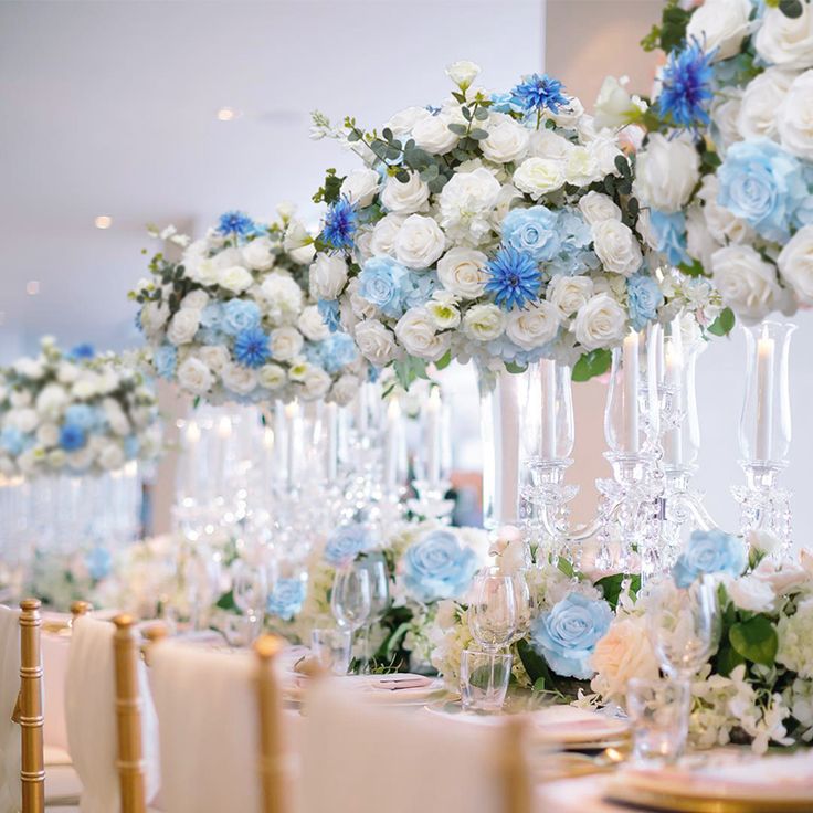 the table is set with blue and white flowers