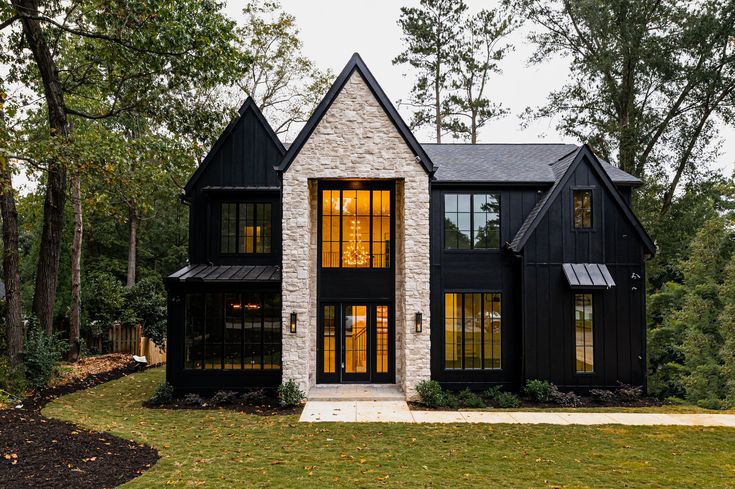 a black and white house surrounded by trees