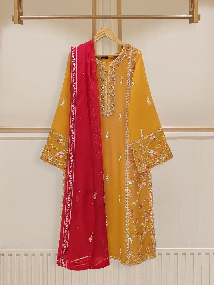 Elegant embroidered cotton net shirt with pants and dupatta a perfect choice for those who appreciate intricate detailing and graceful style. Crafted from high-quality cotton net fabric, this shirt offers a lightweight and luxurious feel, allowing you to feel comfortable and chic throughout the day. The set comes with a matching dupatta and pant which enhances the overall look and adds a touch of finesse to your outfit. Length: 45" Pants Fabric : Raw Silk Dupatta Fabric : Organza Festive Chinon Dupatta With Naqshi, Festive Naqshi Dupatta In Chinon, Navratri Chanderi Traditional Wear With Naqshi, Navratri Festive Naqshi Anarkali Set, Semi-stitched Chinon Lawn Suit With Naqshi Details, Festive Georgette Salwar Kameez With Naqshi Detailing, Semi-stitched Chinon Lawn Suit With Naqshi, Festive Kurta With Dupatta In Cambric, Festive Georgette Salwar Kameez With Naqshi