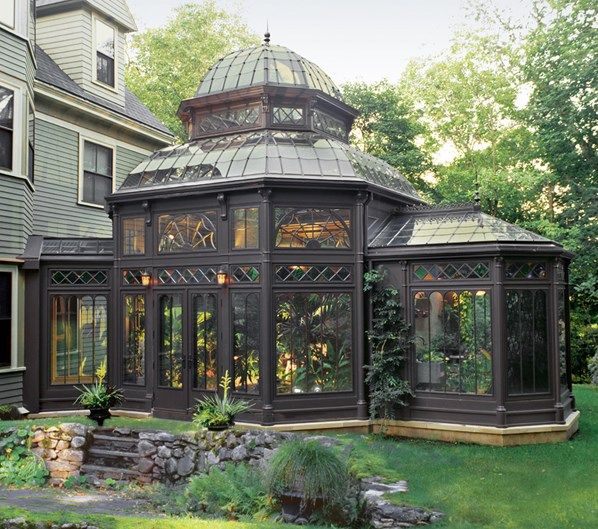 a gazebo in the middle of a yard next to a house