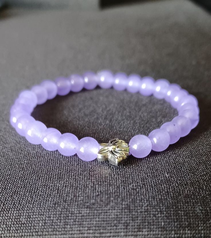 ️ Made with durable, pre-stretched crystal elastic for a perfect fit. ️ Made with lavender 6mm chalcedony stone beads with a lotus flower spacer bead in the middle.  ️ Beautiful in the light. ️ Slight color variations may occur due to flash used in photography and photo enlargement. ️ Bracelet will be shipped within 1 to 3 days except holidays. 📬 ️ If you have any questions, please don't hesitate to contact me. I will do my best to reply as soon as possible. Lavender Beaded Bracelets With 8mm Beads For Gift, Lavender Bracelets With Spacer Beads As Gift, Lavender Bracelets With Spacer Beads For Gift, Lavender 8mm Beads Bracelet Gift, Spiritual Lavender Beaded Bracelets As Gift, Lavender Crystal Bracelet With 8mm Beads As Gift, Spiritual Lavender Beaded Bracelets With 8mm Beads, Lavender Bracelets With Round Beads For Meditation, Lavender Round Beads Bracelets For Meditation