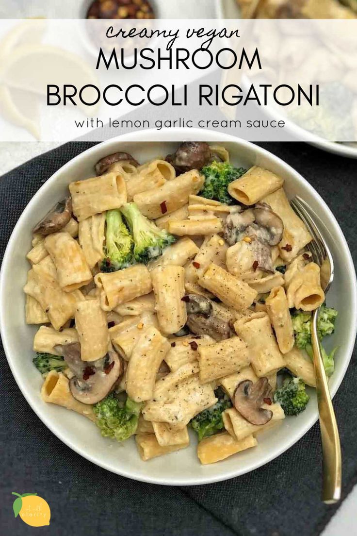 two bowls filled with pasta and broccoli on top of a black place mat