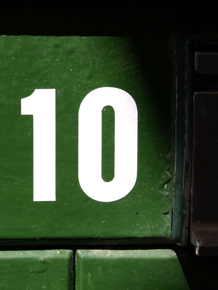 the number ten is displayed in white on a green background with black trimmings