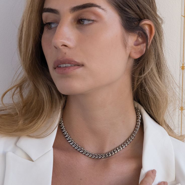 The Cuban 8mm silver chain is the essence of edgy style. A choker style chain that goes with anything, the stainless steel Cuban is the only necklace you'll ever need - but it's also the best layering piece you could want to add to your collection! Silver Cuban Link Jewelry For Everyday, Everyday Silver Cuban Link Jewelry, Trendy Silver Cuban Link Jewelry, Trendy Silver Cuban Link Necklace, Trendy Silver Cuban Link Necklaces, Trendy Silver Necklace With Box Chain, Silver Chic Choker With Adjustable Chain, Chic Silver Choker With Adjustable Chain, Edgy Silver Necklace With Adjustable Chain