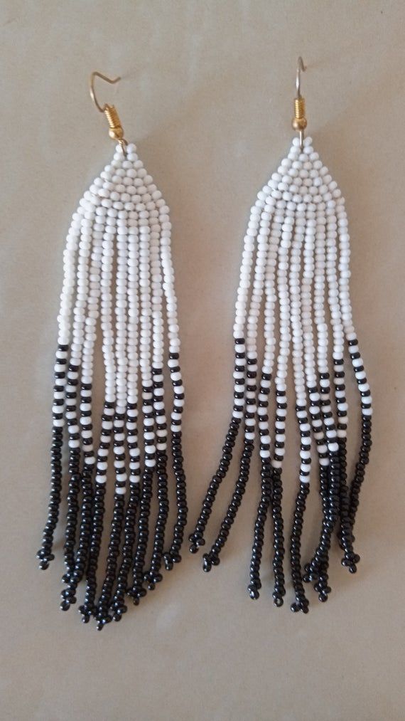 African beaded earrings, Handmade earrings, African jewelry, Maasai jewelry, Earrings for women,Gift for her, Tribal EarringsThese stunning earring are superbly crafted which will absolutely makes stand out in any occasion.Color - White and Black.3-5 days delivery via DHL ExpressThe shipping fee is for the first item only and additional necklaces or items ship for free.Wholesale available at a fair price,please contact me.For any clarification,please send me a convo or an e-mail.Thank you for vi Bohemian White Earrings With Black Beads, White Drop Earrings With Black Beads, White Dangle Jewelry With Black Beads, Traditional White Earrings With Ear Wire, Traditional White Hoop Earrings With Ear Wire, Gift White Beaded Earrings With Black Beads, Traditional Dangle Black Bead Jewelry, Traditional Beaded Earrings With Round Beads, White Beads With Ear Wire For Jewelry Making