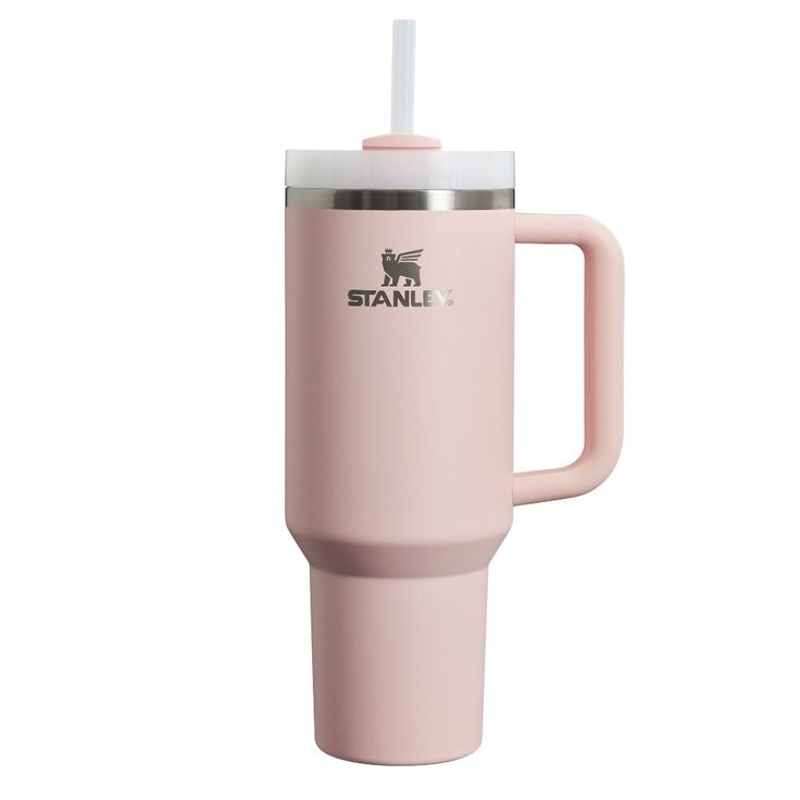 a pink travel mug with a straw sticking out of the lid and handle, on a white background