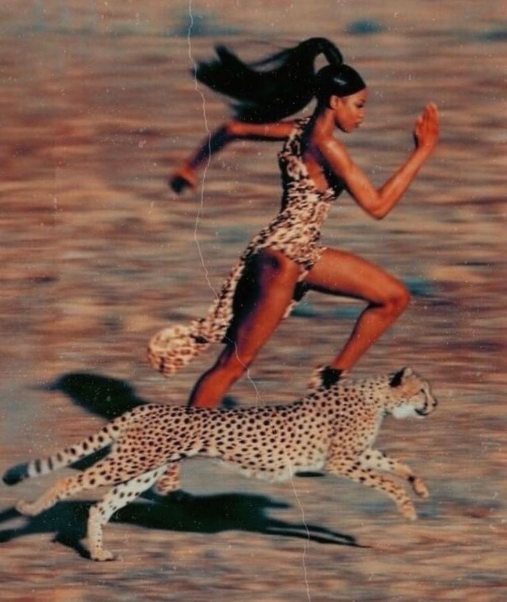 a woman in a leopard print dress running next to a cheetah