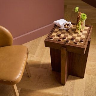 a chair and table with chess pieces on it