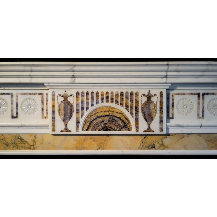 an ornate fireplace surround in marble with decorative designs on the front and back panels above it