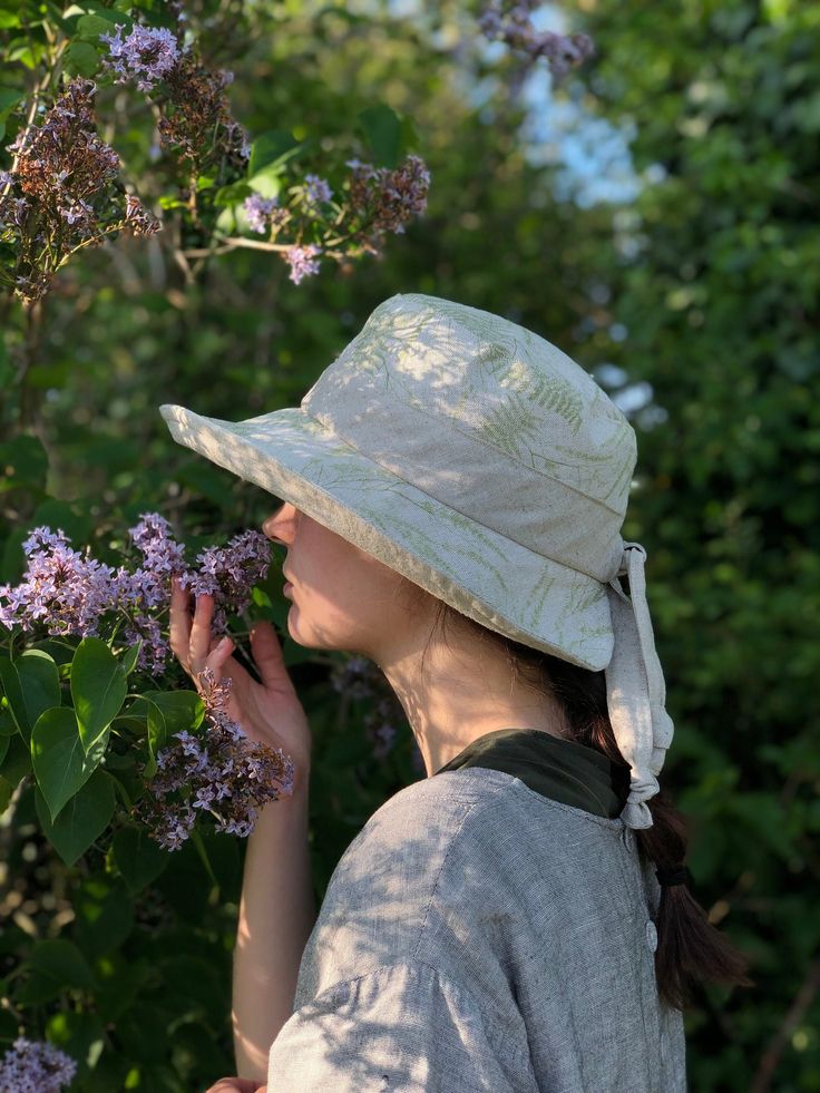 "The 'Emmy' hat, one of my bestsellers.   Made from a beautiful green fern print linen, with an natural linen contrast.   the shape and silhouette of the 'Emmy' hat is very flattering, offering good facial coverage from the suns rays, with a linen tie feature, which if needed also works to slightly tighten the hat size, for those windy days.  The brim width is 9cm at the front scooping to 7cm at the back, with a cut away collar back to offer freedom of movement,  to help stop the hat catching at Beige Brimmed Sun Hat For Spring, Waterproof Hat, Tweed Hat, Large Hat, Country Hats, Printed Linen Fabric, Travel Hat, Large Hats, Fall Hats