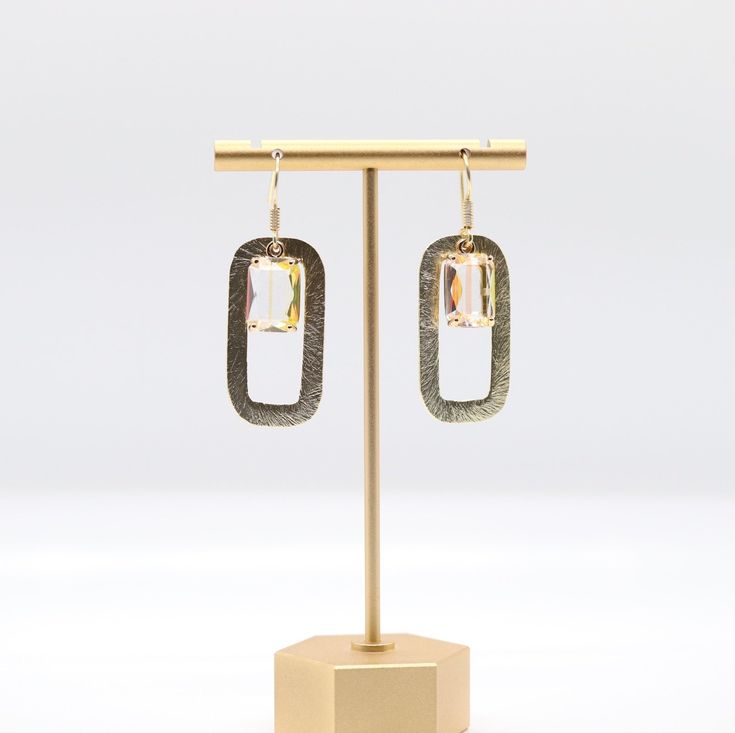 These gold rectangular drop earrings are sure to turn heads. They feature a center citrine stone that adds a touch of glamour and elegance. These earrings make a great gift for any occasion, and the recipient is sure to appreciate their beauty and unique style. Modern Oblong Single Earring Jewelry, Modern Handmade Oblong Earrings, Elegant Single Oblong Earring, Modern Crystal Earrings As A Gift, Gold Rectangular Sterling Silver Earrings, Small Hoop Sterling Silver Earrings For Party, Gold-toned Sterling Silver Rectangular Earrings, Metal Drop Earrings For Pierced Ears, Nickel-free Rectangular Metal Earrings