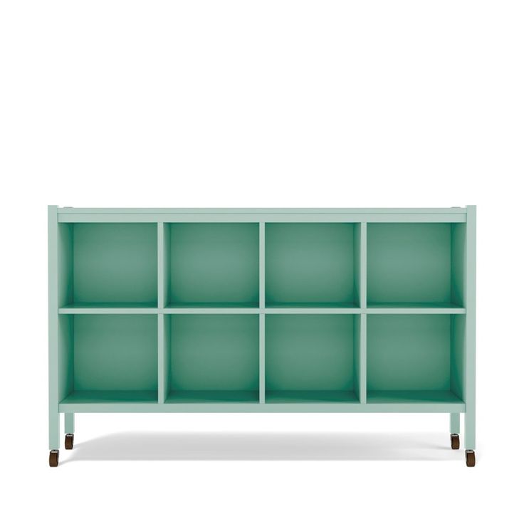 a green shelf with many compartments on it