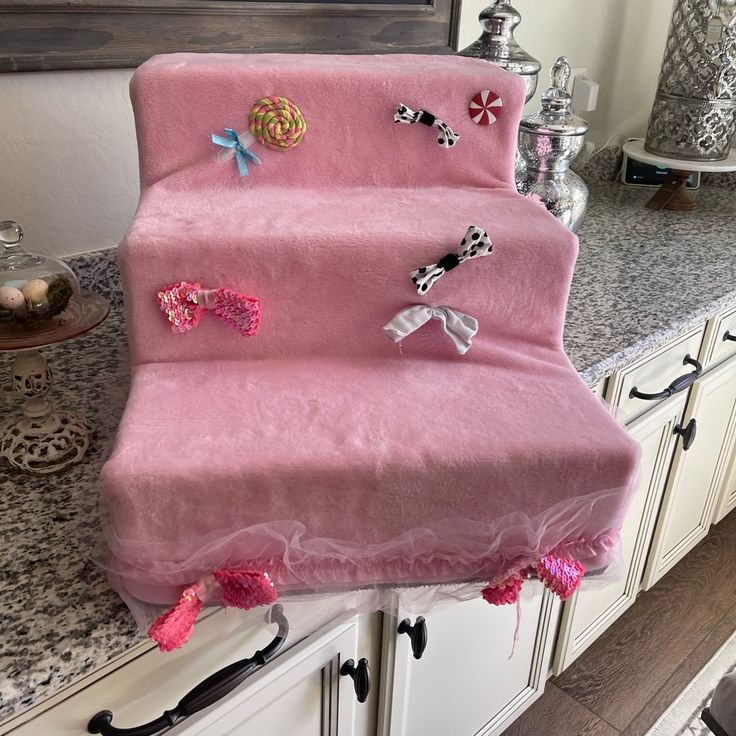 a pink chair covered with lots of hair clips on top of a counter next to a mirror