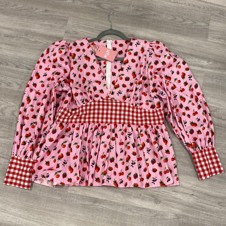 This Adorable Shirt Is From Uk Slow Fashion Brand Molby. It’s A Uk Size 18, Which Is Like Us 14. New With Tags, Zipper Up The Back, Fit And Flare Style, Puff Sleeves. The Proportions Were Off For Me (I Have A Short Waist And Am Very Tall) So I’m Bummed To Sell But I’ve Never Worn It Because Of That. Cute Long Sleeve Red Blouse, Cute Red Long Sleeve Blouse, Casual Long Sleeve Top With Cherry Print, Long Sleeve Cotton Tops With Strawberry Print, Red Strawberry Print Tops For Spring, Red Strawberry Print Top For Spring, Pink Cherry Print Top For Spring, Spring Pink Tops With Cherry Print, Fitted Pink Top With Strawberry Print