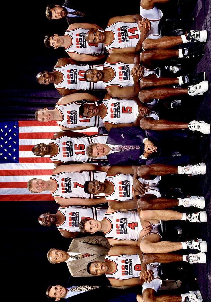 the men's basketball team is posing for a photo in front of an american flag