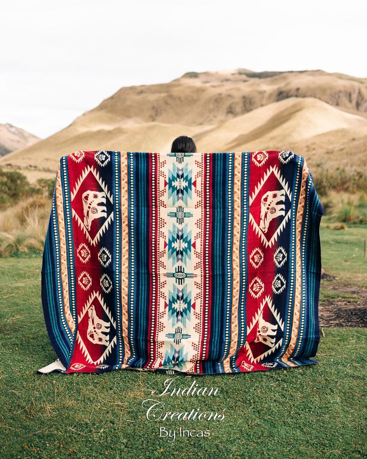 a blanket sitting on top of a lush green field