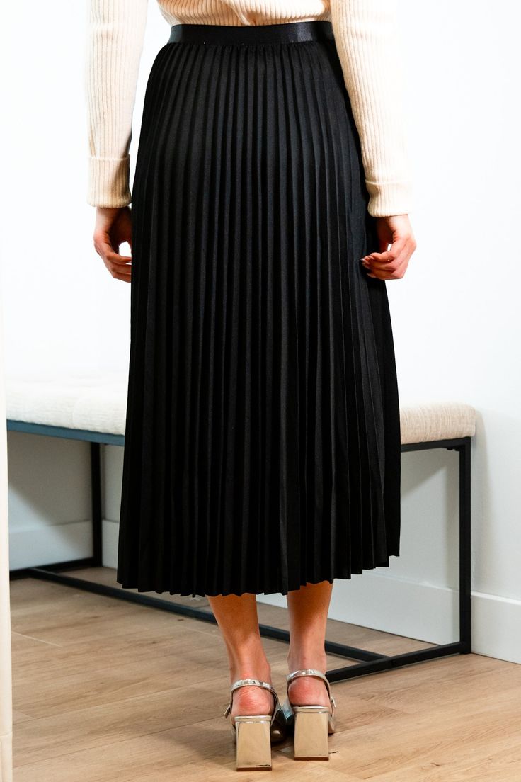 Get ready for an evening out with our Victoria skirt. Featuring a luxurious black accordion pleated design, this midi length skirt exudes elegance and refinement. Elevate any outfit with this chic and sophisticated piece. Elastic satin waistband Mary Grace is wearing XS/S with a 32B bust, 25” waist and 36” hip. 95% Polyester, 5% Spandex Hand wash cold and line dry Chic Pleated Skirt With Folds, Solid Chic Pleated Skirt, Elegant Pleated Skirt For Evening, Elegant Folded Maxi Skirt For Evening, Elegant Evening Maxi Skirt With Folds, Chic Flowy Maxi Skirt With Folds, Relaxed Pleated Maxi Skirt For Night Out, Elegant Midi Skirt With Folds, Pleated Midi Maxi Skirt For Party