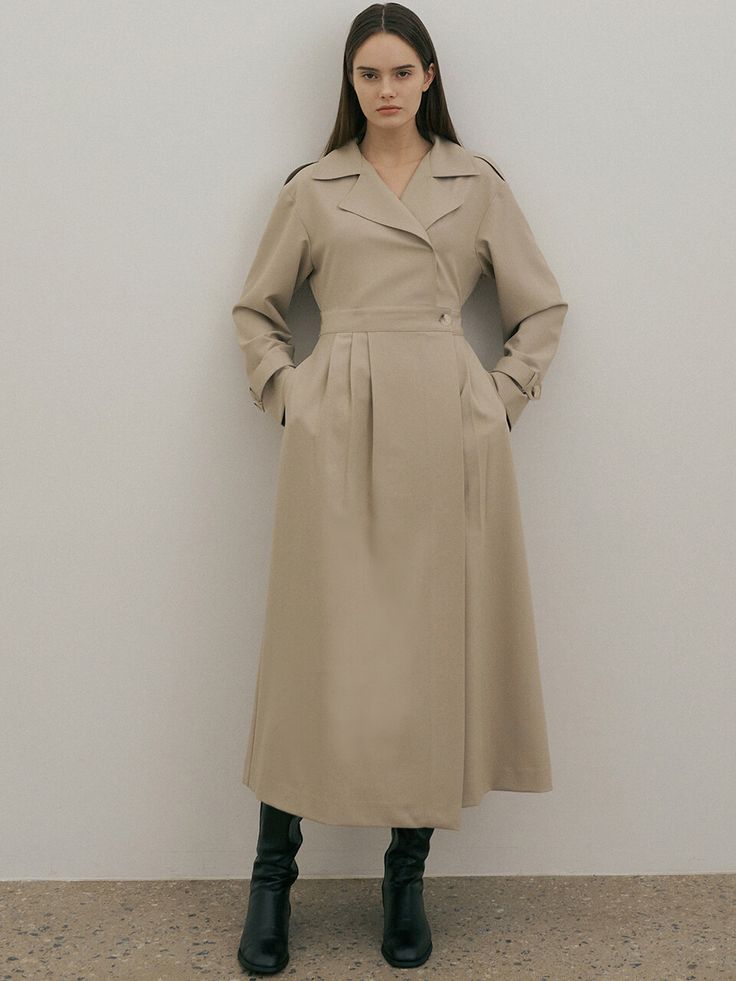 Editor's NoteTrench layered design with a classic and feminine mood. It is possible to adjust S/M size with the fabric belt and skirt waist adjustment button.- Sleeve bijou and shoulder epaulet detail- Use inner buttons on the front skirt to prevent opening during activities.- Point with asymmetric tuck detail on the front of the skirtMeasurements (inch)ONE SIZE (XS-M)- Shoulder: 18.50 in.- Chest: 17.32 in.- Waist: 14.17 in.~15.35 in.(control button +-)- Hem: 25.59 in.- Sleeve: 21.65 in.- Sleeve Opening: - Length: 50.79 in.*One size that can be worn KR44~ 66 by actual measurement*Model Size: Height 5'68, Bust 31, Waist: 23, Hips 35*By measuring the section, an error of 0.4-0.8 inch may occur depending on the measurement location.Composition & Care- 78% Polyester, 18% Rayon, 4% Span- Th Elegant Beige Midi Length Belted Dress, Elegant Beige Belted Dress, Beige Belted Outerwear For Office, Elegant Beige Belted Outerwear, Classic Beige Midi Dress For Office, Elegant Belted Dress With Pockets For Work, Elegant Beige Dress With Belt, Winter Workwear Dress With Belt, Beige Belted Dress For Spring