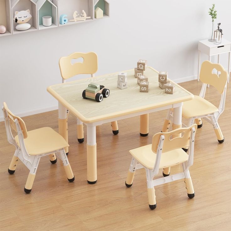 a child's table and chairs in a room