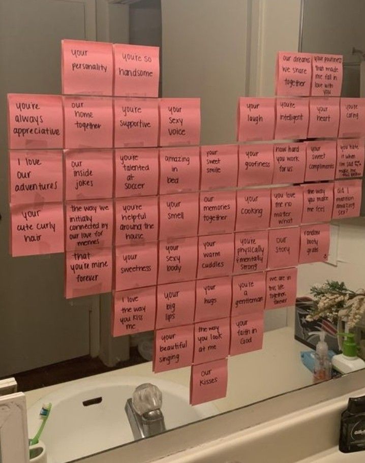 pink sticky notes are hanging on a bathroom mirror