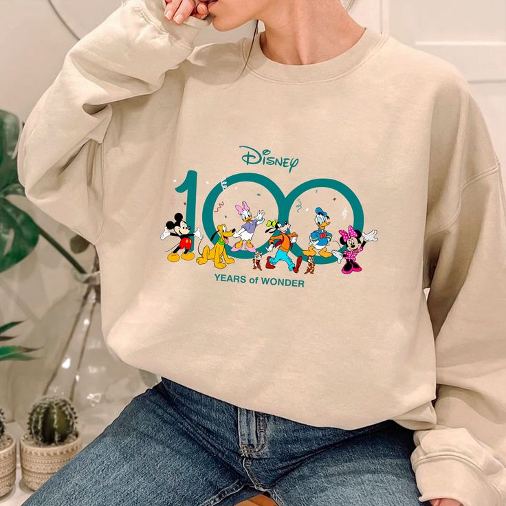 Disney 100 Years Of Wonder Sweatshirt Disney Letter Print Sweatshirt For Fan Events, Disney Cartoon Print Sweatshirt For Fan Events, Long Sleeve T-shirt With Character Print For Disney Events, Casual Crew Neck Sweatshirt With Character Print, Casual Sweatshirt With Character Print, Crew Neck, Disney Style Cotton Sweatshirt With Letter Print, Disney Long Sleeve Letter Print T-shirt, Disney Long Sleeve T-shirt With Letter Print, Cotton Sweatshirt With Cartoon Print For Disney Fan Events