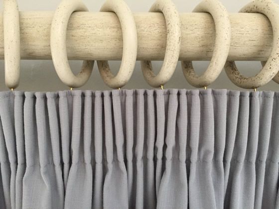 the curtain is closed with rings hanging from it's rod