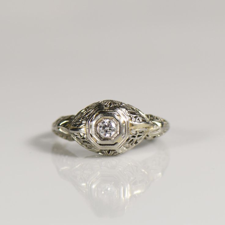 an antique diamond ring with filigree details