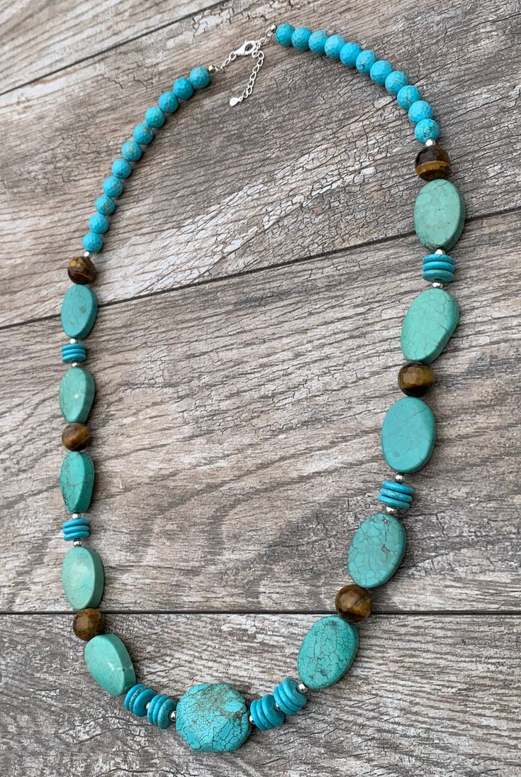 Turquoise Magnesite, Agate & Sterling Silver Statement Necklace Genuine Turquoise Magnesite Genuine Agate Sterling Silver Lobster Claw Clasp Crafted and Finished by Hand Approximate Measurements: Length 30" Adjustable with 2" Extender Live your best life when you are wearing this powerful gemstone statement necklace. This necklace will pair perfectly layered over a turtleneck or tunic or pair with a V-neck t-shirt and a pair of jeans. Handmade Turquoise Agate Beaded Necklaces, Amazonite Necklace With Natural Stones, Chrysoprase Jewelry With Natural Stones For Jewelry Making, Turquoise Gemstone Beads For Jewelry Making, Turquoise Gemstone Necklaces With Round Beads, Green Turquoise Long Necklace With Gemstone Beads, Turquoise Jewelry With Round Natural Stone Beads, Blue Chrysocolla Necklace With Stones, Artisan Chrysocolla Jewelry With Polished Beads