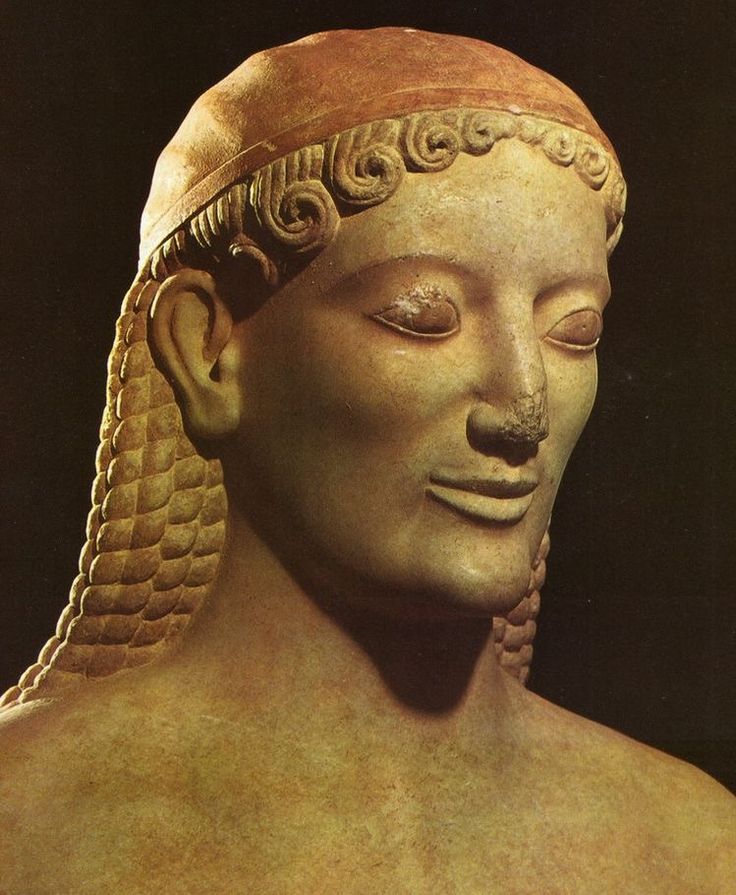 an ancient statue with braids on it's head